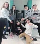  ??  ?? Students Shannon Elliott, left, Molly Sharman, Jacob Colocci, John Velasquez, Cooper Cook and Noah Bowler surprise GreenUp’s Karen O’Krafka during a regular “Around the World” focus group check-in by showing her the newly installed water bottle refill station.