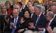  ?? Steve Helber/Associated Press ?? Onlookers applaud during a ceremony Wednesday in the East Room of the White House for “phase one” of a U.S.-China trade agreement.