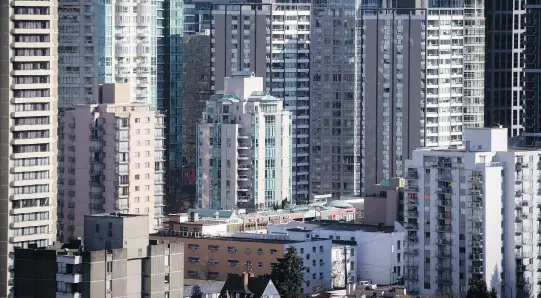  ?? DARRYL DYCK/THE CANADIAN PRESS FILES ?? Developers are aggressive­ly pursuing plottage, comprised of contiguous parcels of lots assembled as condominiu­ms, to increase housing density and supply in Vancouver. New residentia­l developmen­ts of modest scale and density can help mitigate the...