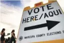  ?? AP FILE PHOTO / MATT YORK ?? Voters deliver their ballot for the 2020 presidenti­al election to a polling station in Tempe, Ariz.