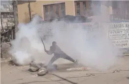  ?? — AP ?? A Kashmiri villager hits an exploded teargas shell fired at them by government forces after they were stopped from taking part in the funeral procession of Kashmiri rebel Mussavir Wani in Pulwama, about 35km south of Srinagar on Saturday. Thousands...