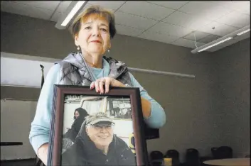  ?? Michael Quine Las Vegas Review-Journal @Vegas88s ?? After a Veterans Coffee &amp; Conversati­ons gathering at Vegas PBS on Nov. 17, Barbara Rodgick, 67, holds a photo of her late husband, Bill, who was a Vietnam War veteran exposed to Agent Orange.