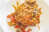  ?? LAUREN DELGADO/STAFF ?? The pad key mow, or drunken wide noodles, piles together red bell peppers, mushrooms, carrots, noodles and Thai basil for a savory mix.