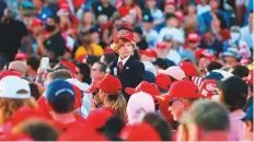  ?? AFP ?? A young supporter looks on before a rally for President Donald Trump on Friday, in Pensacola, Florida.