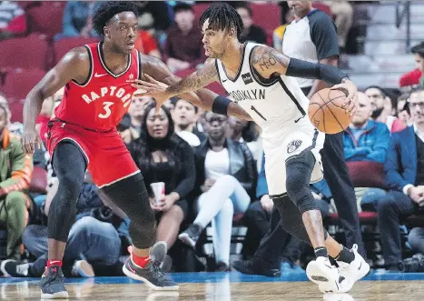  ?? GRAHAM HUGHES/THE CANADIAN PRESS ?? Toronto’s OG Anunoby defends Brooklyn’s D’Angelo Russell during an NBA Canada Series pre-season game Wednesday night at Montreal’s Bell Centre, where the Raptors scored a 118-91 victory over the Nets in front of the team’s enthusiast­ic Quebec fans.