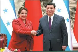  ?? FENG YONGBIN / CHINA DAILY ?? The presidents shake hands during a signing ceremony in Beijing on June 12.
