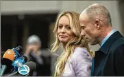  ?? JEENAH MOON / NEW YORK TIMES ?? Stephanie Clifford, aka porn star Stormy Daniels, speaks to reporters in April after a hearing involving former Trump attorney Michael Cohen. At left is Clifford’s attorney, Michael Avenatti.