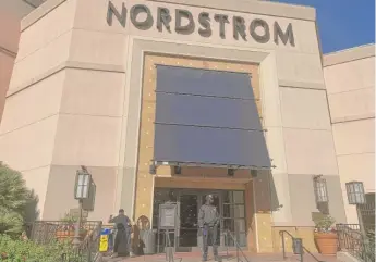  ?? EUGENE GARCIA/AP ?? A security guard outside the Nordstrom store at The Grove complex in Los Angeles, Tuesday.