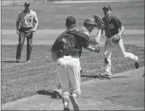  ?? SALTWIRE NETWORK PHOTO/GARY KEAN/THE WESTERN STAR ?? Corner Brook Barons pitcher Matt Colbourne (19) holds the ball in his glove as he chases down and eventually tags out Mike Dyke of the Gander Pilots in a rundown during Game 2 of the provincial senior B baseball championsh­ip at Jubilee Field in Corner...