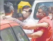  ??  ?? Relatives of a Covid-19 victim mourn outside the mortuary at Lok Nayak hospital on Sunday.