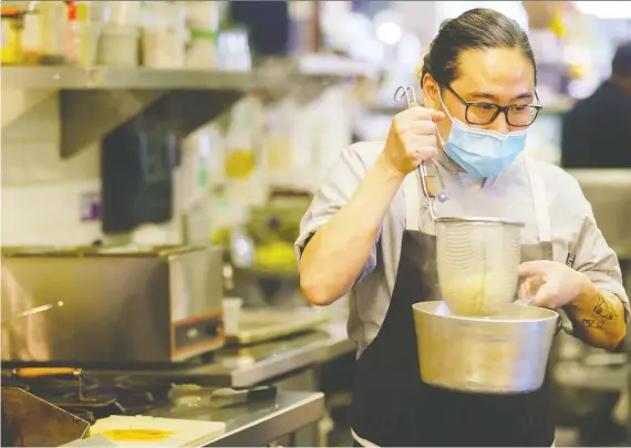  ?? PHOTOS: DRE KWONG ?? Kaede Hirooka, co-owner and chef of Respect the Technique, prepares his shrimp and pork won ton ramen. His pop-up has been operating since 2019.