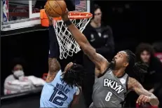  ?? Kathy Willens / Associated Press ?? Brooklyn Nets center Deandre Jordan tries to tip the ball away from Memphis Grizzlies guard Ja Morant during the first quarter of a game on Dec. 28, 2020.