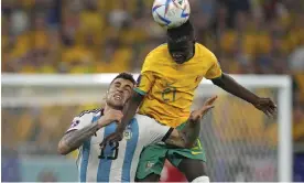  ?? Photograph: Lee Jin-man/AP ?? Young Socceroo Garang Kuol challenges Argentina's Cristian Romero during their World Cup round of 16 match in Qatar.