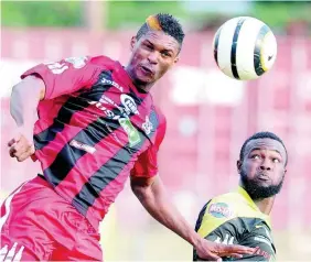  ?? FILE ?? Andre Clennon, formerly of Arnett Gardens, wins a header over Ramone McGregor of Barbican in a Red Stripe Premier League match on January 18, 2015.