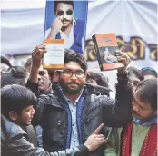  ?? PHOTO: PTI ?? Gujarat MLA Jignesh Mevani ( centre), former student leader Kanhaiya Kumar ( left) and farmers’ leader Akhil Gogoi, with the picture of Dalit outfit Bhim Army founder Chandrashe­khar Azad in the background, during a rally in New Delhi on Tuesday