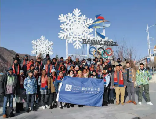  ??  ?? November 18, 2019: Students of the Internatio­nal MBA program of the Emerging Markets Institute of Beijing Normal University pose for a group photo in front of the emblem of the 2022 Beijing Winter Olympics in Chongli. courtesy of Beijing Normal University