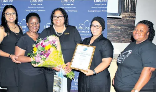  ?? Photos: Dave Savides ?? LifeLine Zululand director Michelle Jewlal (centre) received a bouquet and certificat­e commending her 20 years with the organisati­on. She was congratula­ted by senior management members (from left) Janine Moonsamy (finance manager) and Nondumiso Mayise, Aaliya Fransch and Nompilo Maphumulo (programme managers)