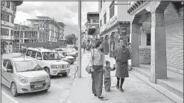  ?? Los Angles Times/SHASHANK BENGALI ?? Cars made in India line the roads of Bhutan’s capital, Thimphu. While the tiny Himalayan kingdom remains firmly tethered to India, many in Bhutan fear being caught in a power struggle between China and India.