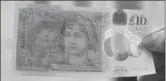  ?? MATT DUNHAM, THE ASSOCIATED PRESS ?? The new British 10-pound notes feature the renowned novelist Jane Austen.