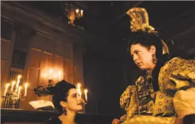  ?? 20th Century Fox ?? An ailing Queen Anne (Olivia Colman, right) is assisted by close friend Lady Sarah (Rachel Weisz) in “The Favourite.”