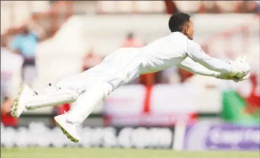  ??  ?? Wicketkeep­er Shane Dowrich takes a sensationa­l catch to dismiss ben Stokes. He then returned to score 38 valuable runs in partnershi­p with Kemar Roach.