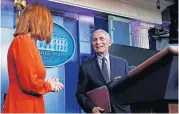  ?? [ALEX BRANDON/ THE ASSOCIATED PRESS] ?? White House press secretary Jen Psaki speaks with Dr. Anthony Fauci, director of the National Institute of Allergy and Infectious Diseases, during a press briefing in the James Brady Press Briefing Room at the White House, Thursday in Washington.