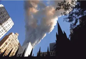  ?? MARIO TAMA/GETTY IMAGES/TNS ?? Smoke spews from a tower of the World Trade Center on Sept. 11, 2001, after two hijacked airplanes hit the twin towers in a terrorist attack on New York City.