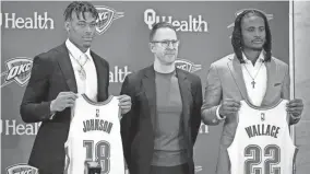  ?? BRYAN TERRY/THE OKLAHOMAN ?? Thunder general manager Sam Presti poses for a photo with draft picks Keyontae Johnson, left and Cason Wallace on June 24.