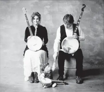  ?? Jim McGuire ?? ABIGAIL WASHBURN and Béla Fleck with son Juno . The couple perform at the Broad Stage on Saturday.