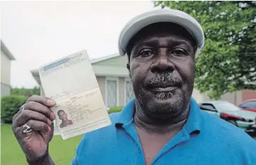  ?? DEREK OLIVER WATERLOO REGION RECORD FILE PHOTO ?? Family friend Sydney Ramsay holds the passport of murder victim Wayne Mohan on June 24, 1996, two days after Mohan was fatally shot at the Oriental Sports Club.