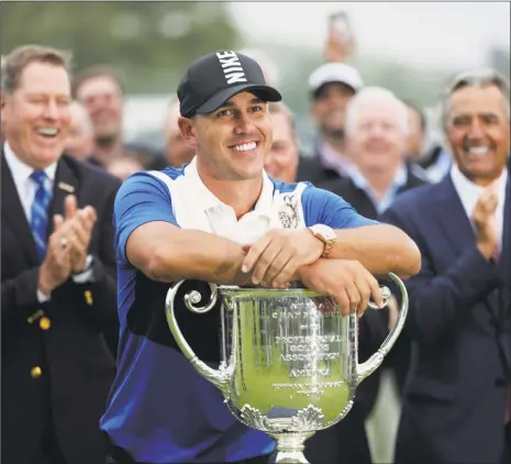  ?? Julio Cortez / Associated Press ?? Brooks Koepka poses with the Wanamaker Trophy after winning the PGA Championsh­ip at Bethpage Black in Farmingdal­e, N.Y.