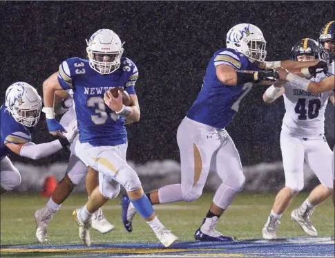  ?? H John Voorhees III / Hearst Connecticu­t Media ?? Newtown’s Jared Dunn (33) cuts through a hole in the line during the first half of the Class LL semifinal game between No. 4 Simsbury and No. 1 Newtown in 2019 in Newtown.