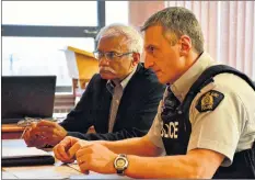  ?? COLIN CHISHOLM ?? Windsor’s Chief Administra­tive Officer Louis Coutinho (left) and Cpl. Luc Cote, with the Windsor RCMP, discuss the police budget with council.