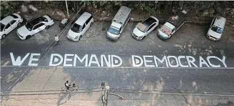  ?? Picture: REUTERS ?? FIGHT FOR DEMOCRACY: A protest slogan is displayed during a demonstrat­ion against the military coup in Yangon, Myanmar yesterday