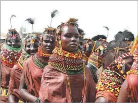  ?? ?? People dressed in traditiona­l Turkana attire wait to go on stage in Lodwar, Kenya, on Oct 12.