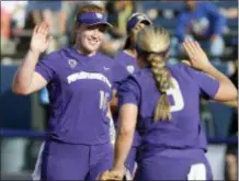  ?? BRYAN TERRY — THE OKLAHOMAN VIA AP ?? Washington’s Gabbie Plain (16) celebrates with Taylor Van Zee (3) after the second inning of the Huskies 6-2 win over top-seeded Oregon in the NCAA Women’s College World Series on Friday.
