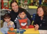  ?? SUBMITTED PHOTO ?? Melinda Hardie (right) with some of the knitted mittens and hats that went to children at Tick Tock Early Learning Center.