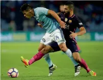  ?? Reuters ?? Celta Vigo’s Facundo Roncaglia (left) and FC Barcelona’s Arda Turan vie for the ball during their Spanish League match.