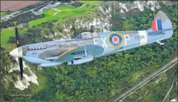  ??  ?? Aero Legends’ Spitfire above the National Memorial to The Few in Capel-le-Ferne