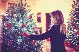  ?? TWITTER/@FLOTUS ?? Melania Trump checks out the White House Christmas decor she designed.