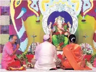  ??  ?? Priests and organisers perform ‘aarti’ at ‘Mumbai Cha Raja’ in Lal Baug area of Parel on Ganesh Chaturthi