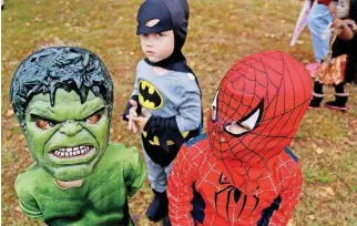  ?? [PHOTO BY JIM BECKEL, THE OKLAHOMAN ARCHIVES] ?? A trio of superheroe­s from years past attend Trick or Treat City at Joe B. Barnes Regional Park. This year’s event will be Saturday.