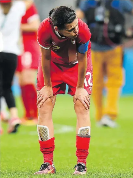  ?? — GETTY IMAGES ?? A dejected Christine Sinclair hunches over on the pitch at Mineirao Stadium in Belo Horizonte, Brazil, after Canada lost 2-0 to Germany in their Olympic women’s soccer semifinal.