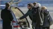  ?? GIUSEPPE LAMI — ANSA VIA AP ?? Gerardo Di Agostino touches the coffin of his sister, Italian victim Fabrizia Di Lorenzo, as her parents, Gaetano Di Lorenzo, second from right, hug his wife Giovanna, right, upon their return from Berlin at Rome’s military airport of Ciampino...