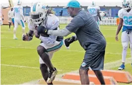  ?? CHARLES TRAINOR JR/AP ?? Running back Jay Ajayi is shown here running a drill on Monday before he was hit during practice and suffered a concussion.
