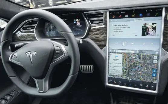  ?? DREW ANGERER/ BLOOMBERG ?? Analysts are examining the future of vehicles such as Tesla Model S P90D, which has some autopilot features, as companies race to bring out the first full self-driving car. Morgan Stanley expects self-driving vehicles will leave people with time to...