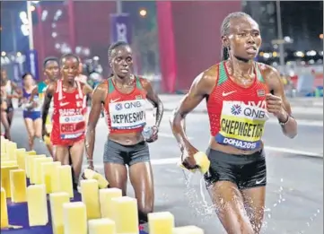  ?? AP ?? ■ Ruth Chepngetic­h of Kenya (right) said ‘training in a hot area’ helped her tackle the conditions after claiming gold in women’s marathon at the World Athletics Championsh­ips in Doha on Saturday.