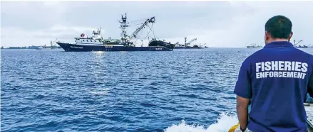  ?? Photo: RNZ Pacific ?? A Marshall Islands Fisheries Enforcemen­t Officer heads out to conduct document checks and inspection­s of an arriving purse seiner in port Majuro prior to start of tuna transshipm­ent operations.