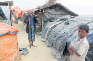  ?? REUTERS ?? An elderly Rohingya refugee walks inside the Palong Khali camp near Cox’s Bazar in Bangladesh on Sunday.