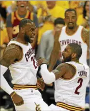  ?? TIM PHILLIS - THE NEWS-HERALD ?? LeBron James and Kyrie Irving celebrate during the first quarter on May 1 at Quicken Loans Arena.